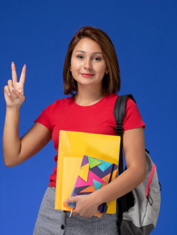 front-view-young-female-student-red-shirt-wearing-backpack-holding-files-copybook-posing-blue-background (1) front-view-young-female-student-red-shirt-wearing-backpack-holding-files-copybook-posing-blue-background (1)